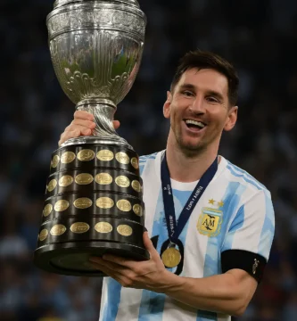 Lionel Messi smiling while holding the Copa América trophy after Argentina's victory